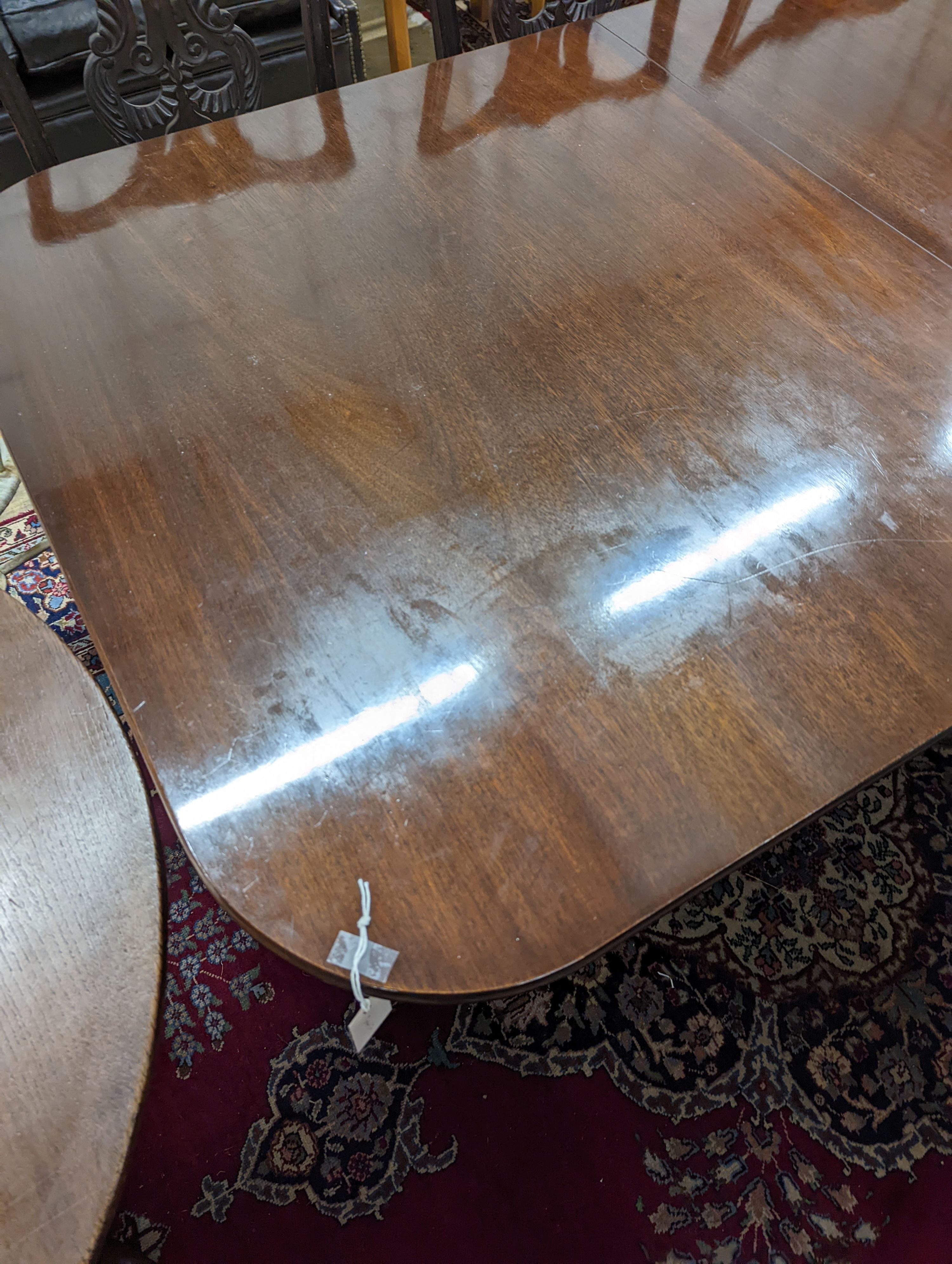 A reproduction George III style rectangular mahogany extending dining table, 241cm extended, one spare leaf, depth 104cm, height 74cm